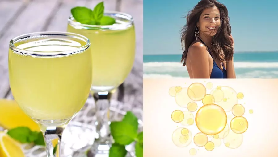 Mulher na praia curtindo um dia de sol ao lado de uma taça de limonada fresquinha.
